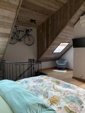 a bedroom with a bed and a bike on the wall at Vélo 94 bij Soof in Geel