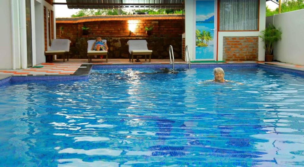 a man swimming in a swimming pool at Dr Nisha's Vedic Remedies in Trivandrum