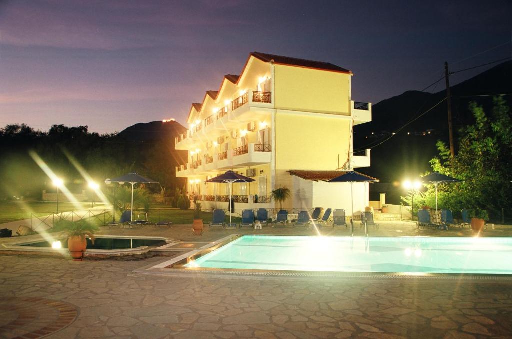 a hotel with a swimming pool in front of a building at Byzantio Hotel & Apartments in Parga