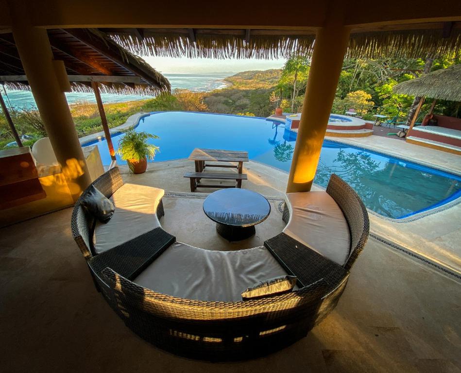 salon ze stołem i basenem w obiekcie Hotel Vista de Olas w mieście Playa Santa Teresa