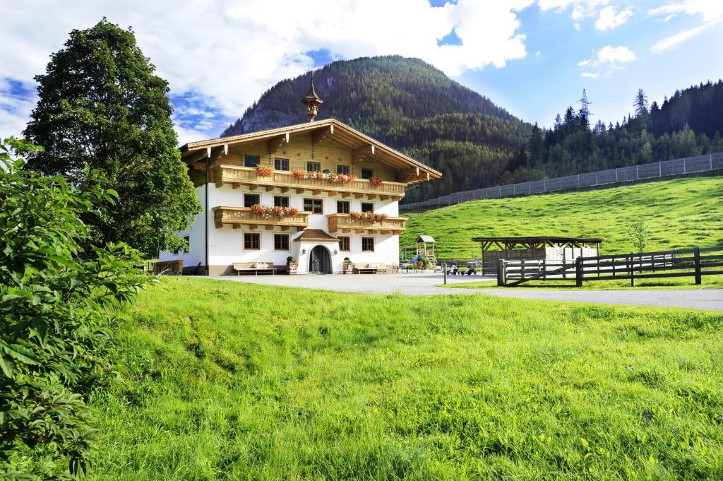 a building in the middle of a green field at Wieslbauer in Flachau
