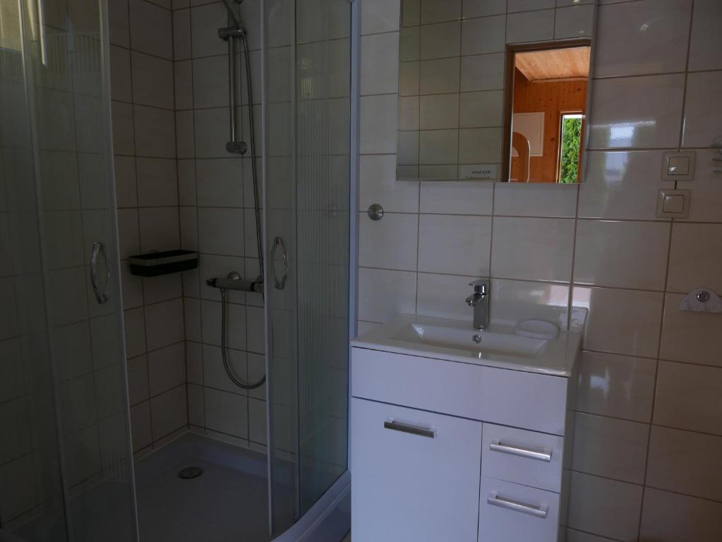 łazienka z umywalką i prysznicem w obiekcie Ferienhäuser mit Pool w Rewalu