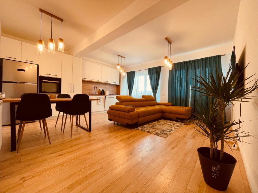 a kitchen and living room with a couch and a table at A&Y APARTAMENT in Floreşti