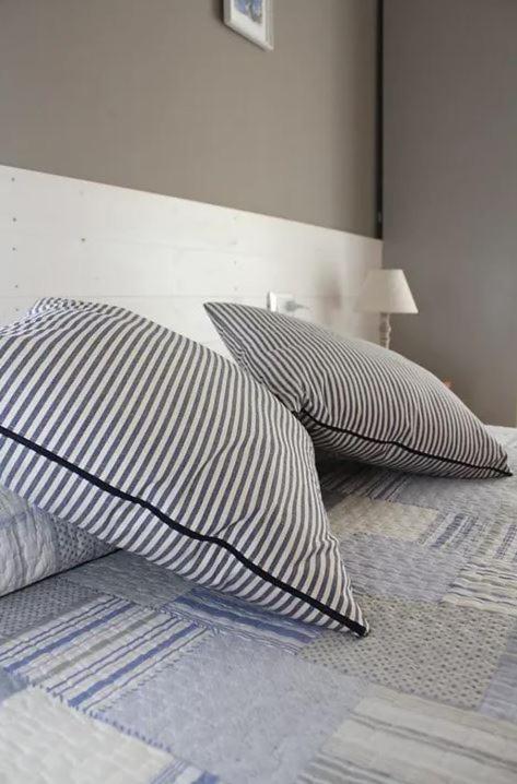 two pillows on a bed in a bedroom at Hotel Villa Argentina in Riomaggiore