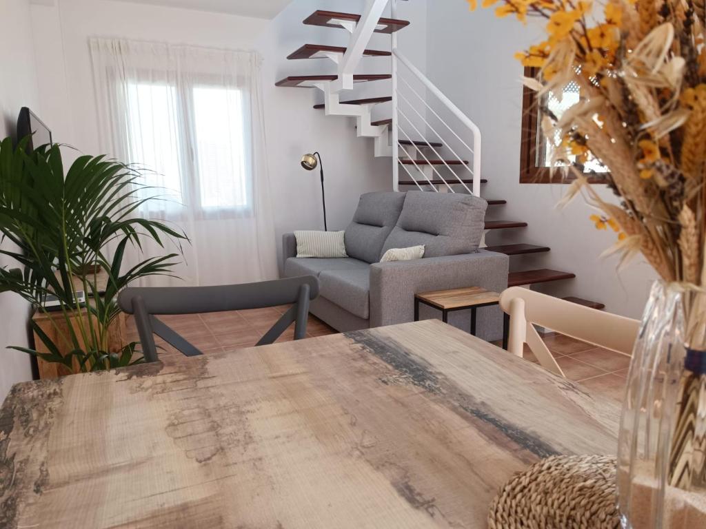 a living room with a table and a staircase at Vista Volcán in Lajares