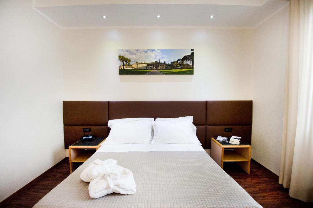 Postel nebo postele na pokoji v ubytování Hotel Minerva