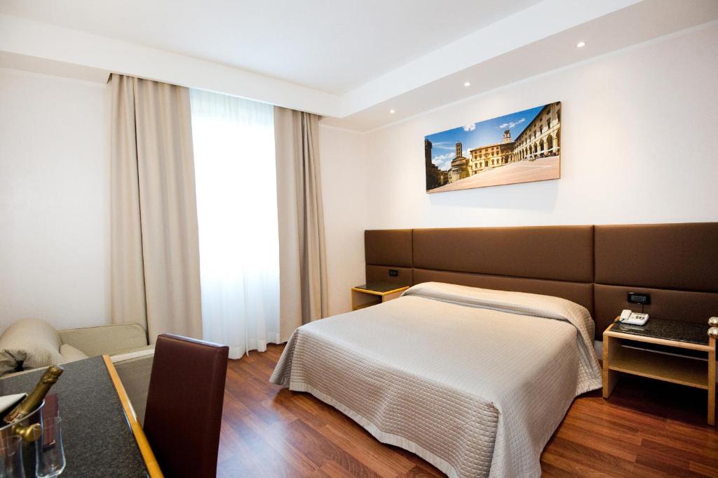 Postel nebo postele na pokoji v ubytování Hotel Minerva