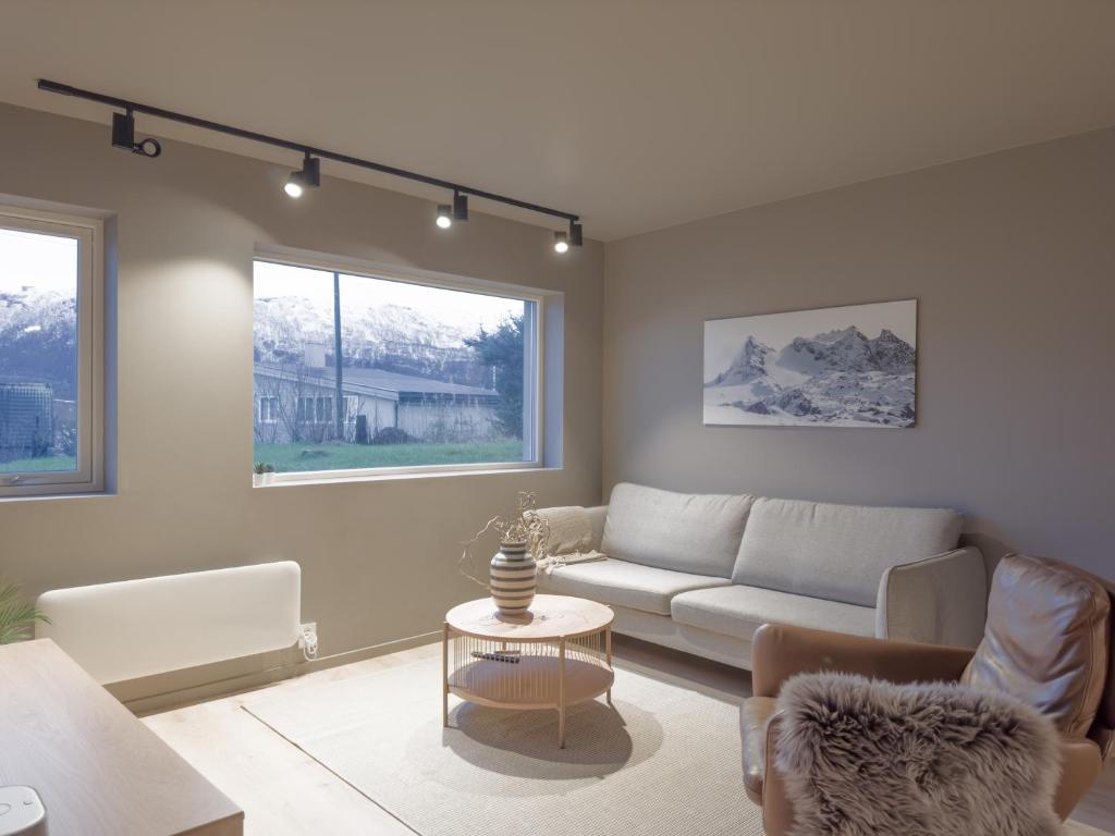 a living room with a couch and a table at Staying Apt 1 - New and modern in Tromsø