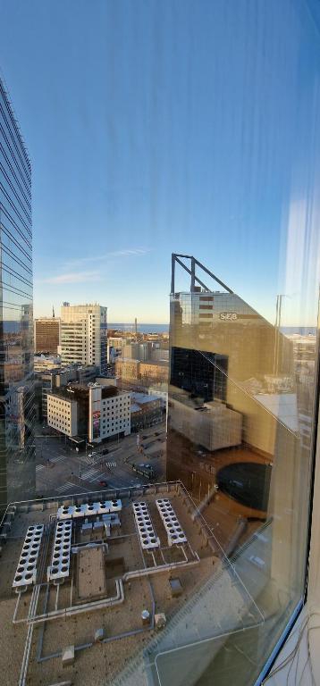 a view of a city from a glass window at Luxury Nightlights NELLI Apartment in Tallinn