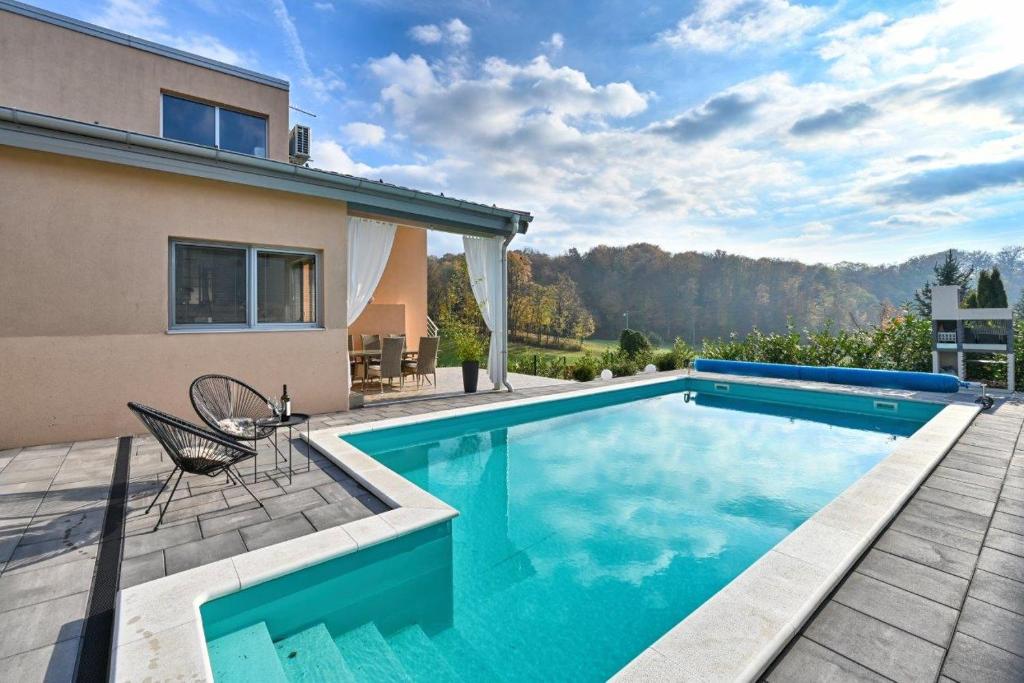 a swimming pool in the backyard of a house at Holiday Home Hanna Toplice Sveti Martin in Sveti Martin na Muri