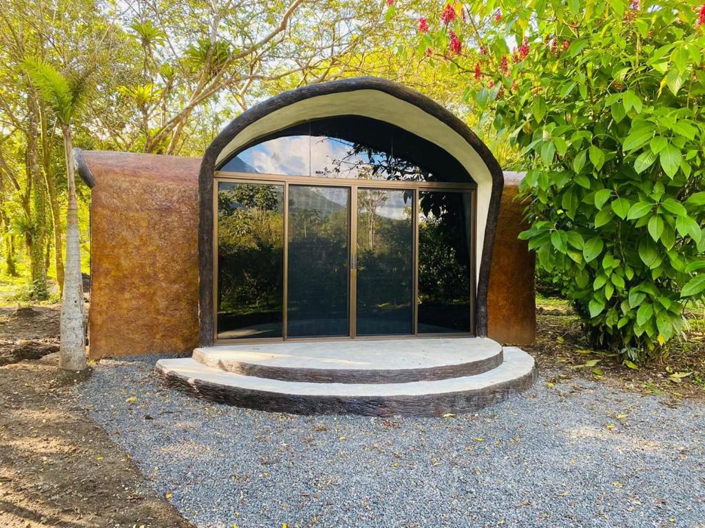 a building with a glass door and some trees at Wellness Park CR in Fortuna