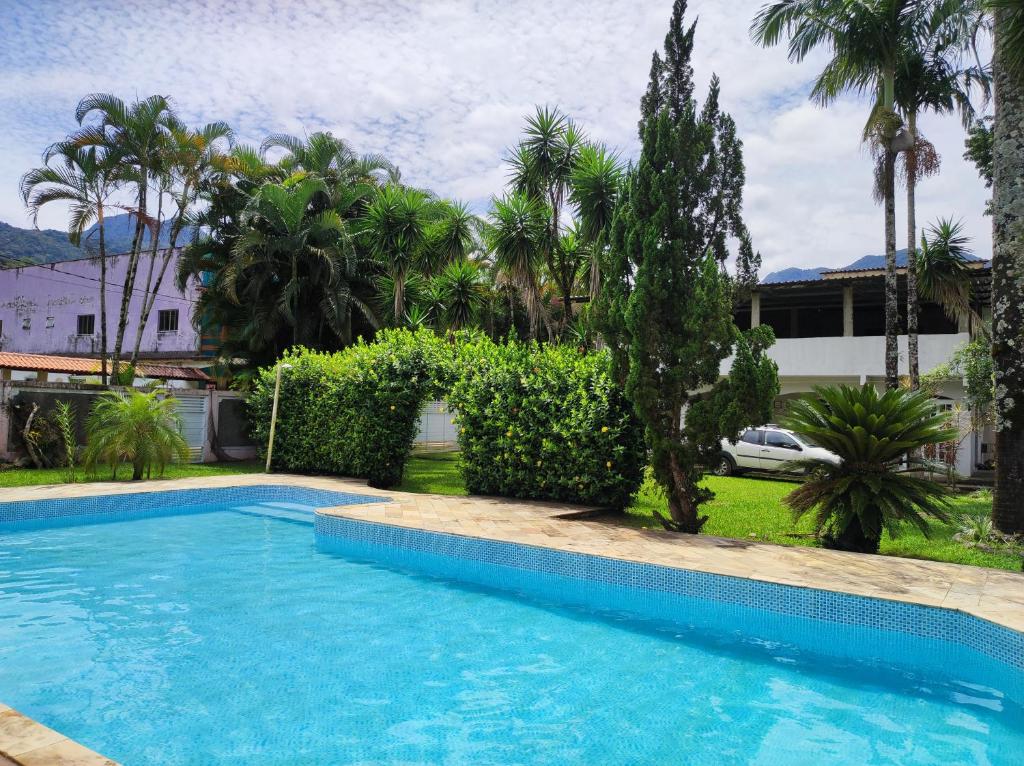 a swimming pool in a yard with trees and a house at Casa com piscina em Aldeia Velha in Quartéis