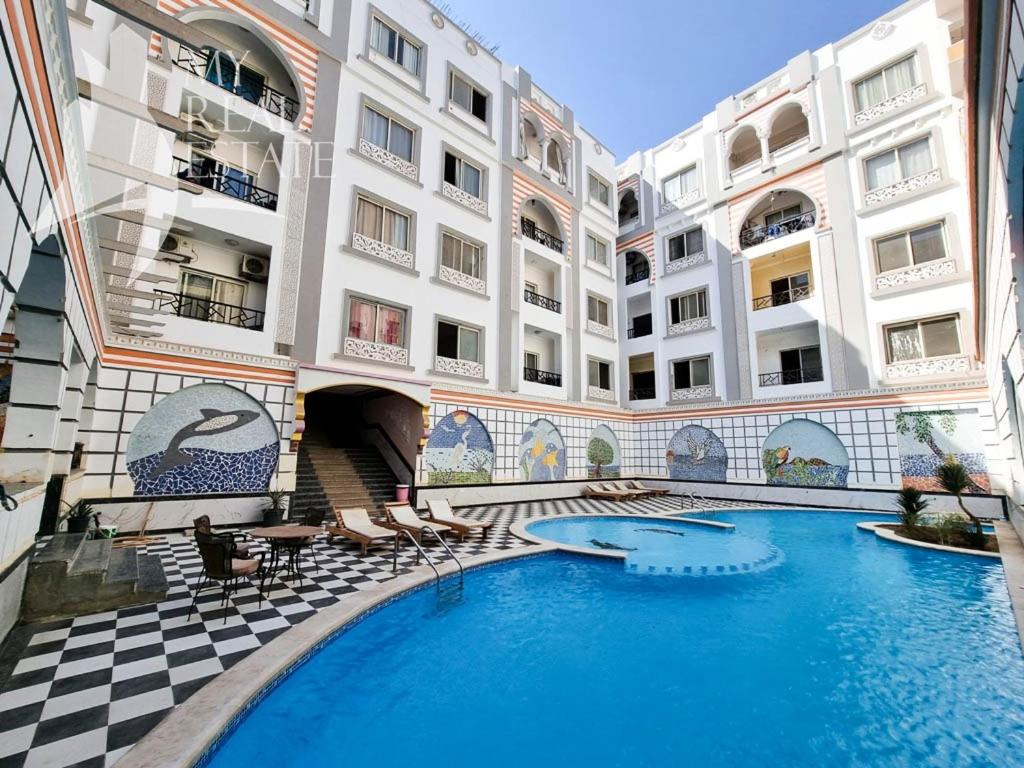 a swimming pool in the middle of a building at One Bedroom with Balcony WI-FI Downtown Sheraton Plaza 226 in Hurghada