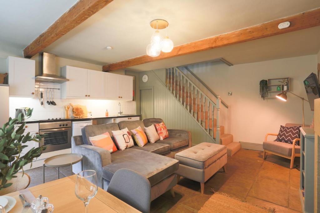 a living room with a couch and a table at Weavers Retreat by Weavers of Haworth in Haworth