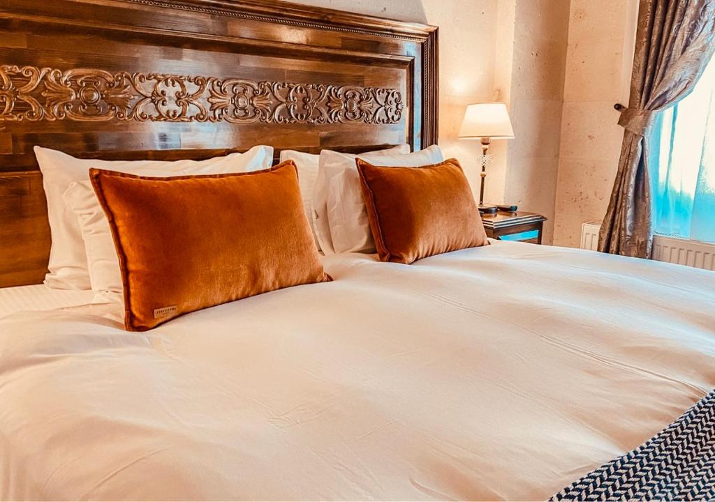 Postel nebo postele na pokoji v ubytování Osmanli Cappadocia Hotel