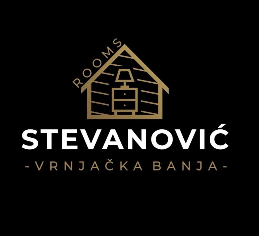 un logotipo para una casa de madera sobre fondo negro en Stevanovic Smestaj, en Vrnjci