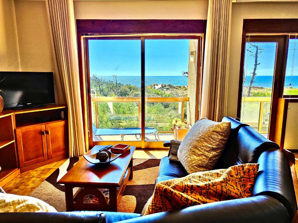 a living room with a couch and a view of the ocean at Casa da Amorosa com Vista Mar by Lethes Legacy in Abelheira