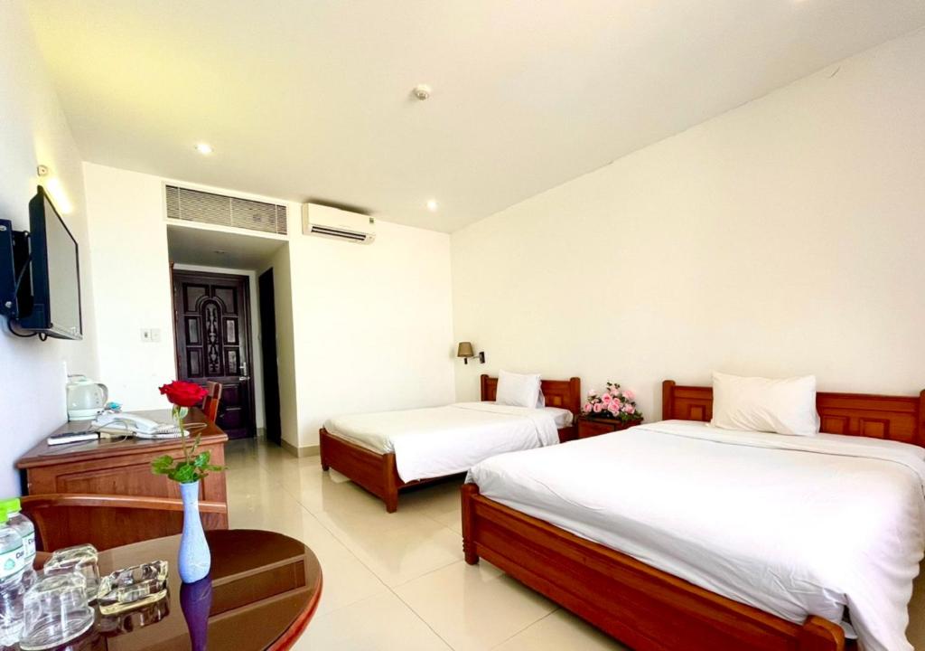 Voodi või voodid majutusasutuse My Khe 2 Da Nang Seafront Hotel toas