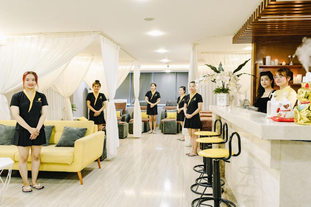 a group of people standing in a salon at Happy Day Riverside Hotel & Spa Danang by Haviland in Danang