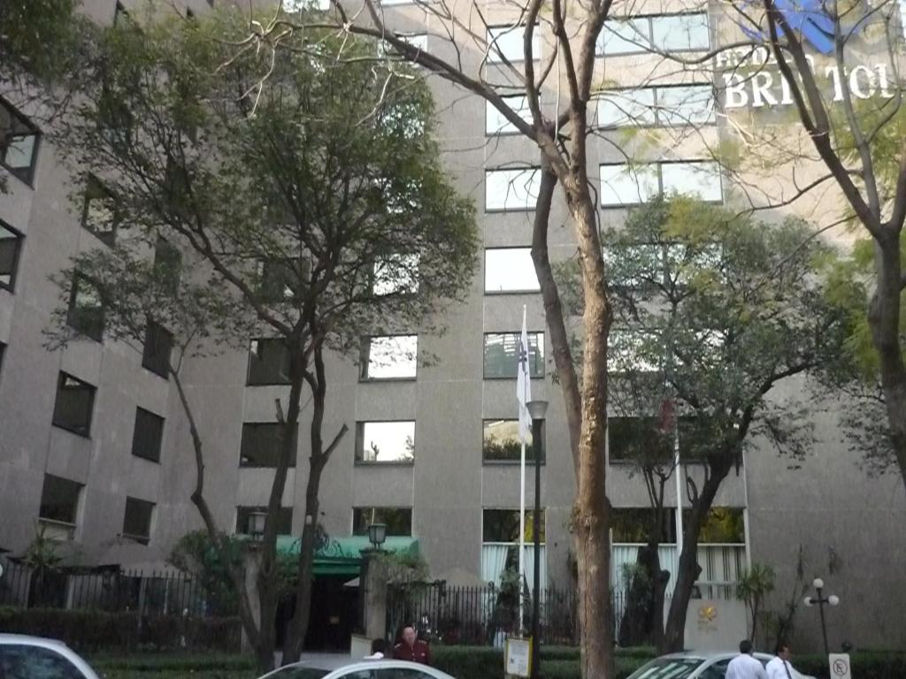 a building with cars parked in front of it at Hotel Bristol in Mexico City