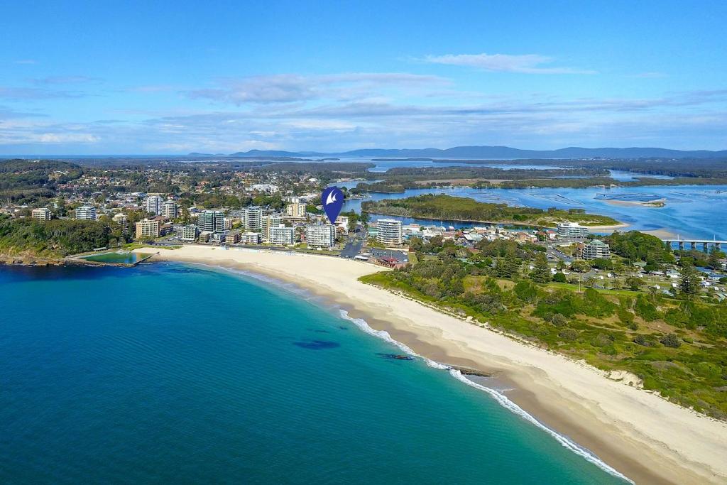an aerial view of a beach and the ocean at Ebbtide 26 in Forster