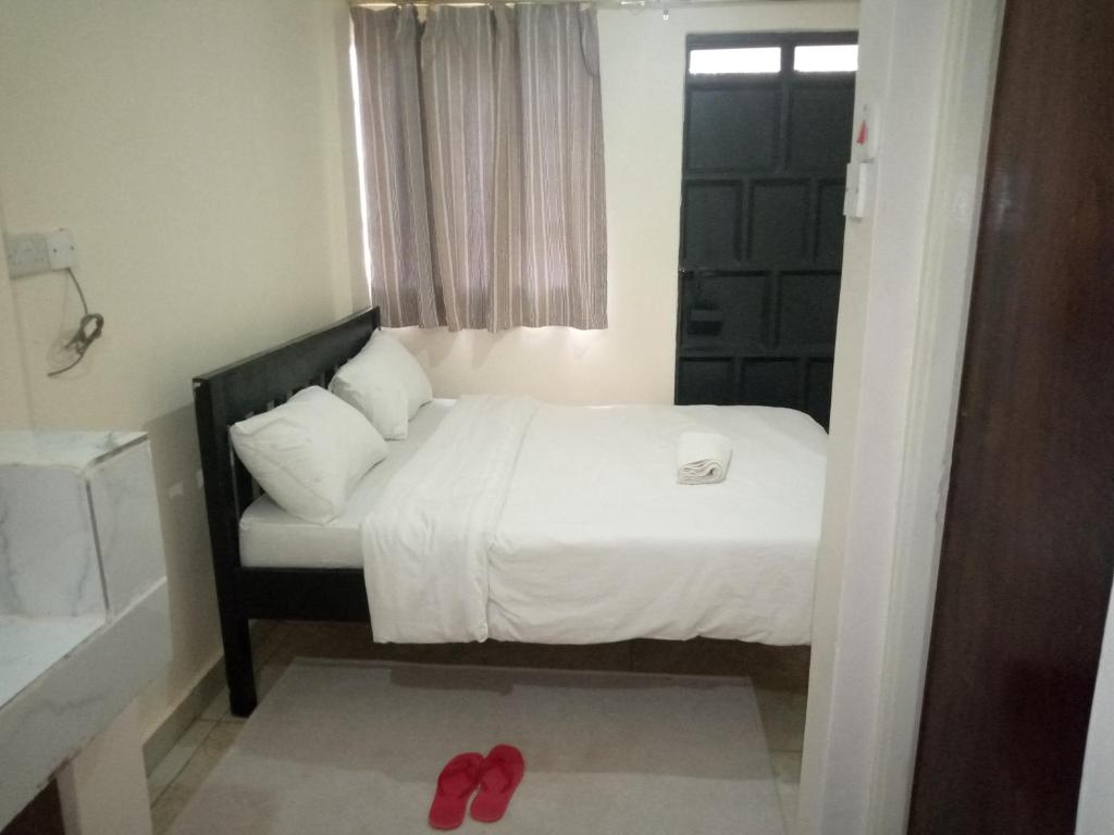 a bedroom with a bed and a pair of red shoes at The pinnacle in Kikuyu