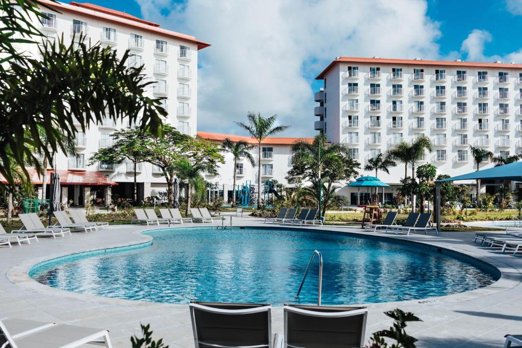 a swimming pool in front of a hotel at Crowne Plaza Resort Saipan in Garapan