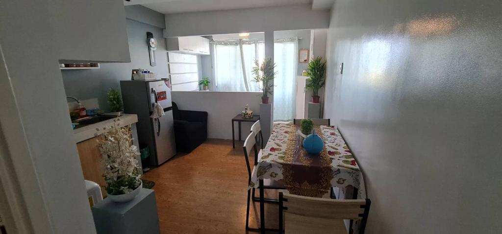 a small kitchen with a table and a dining room at San Remo Oasis in Cebu City
