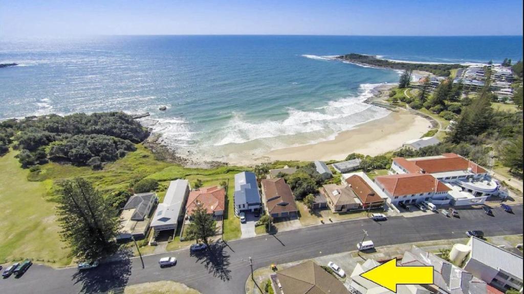 an aerial view of a beach with houses and the ocean at 1 5 Pilot Street Yamba in Yamba