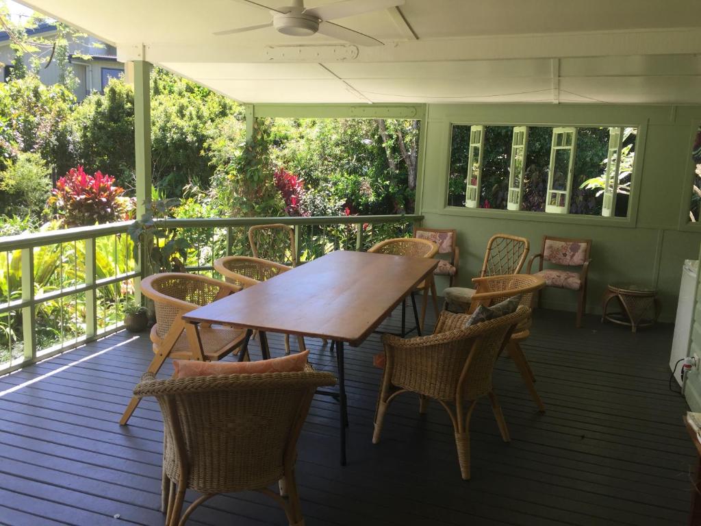a wooden table and chairs on a porch at Pottsville Beach House in Pottsville