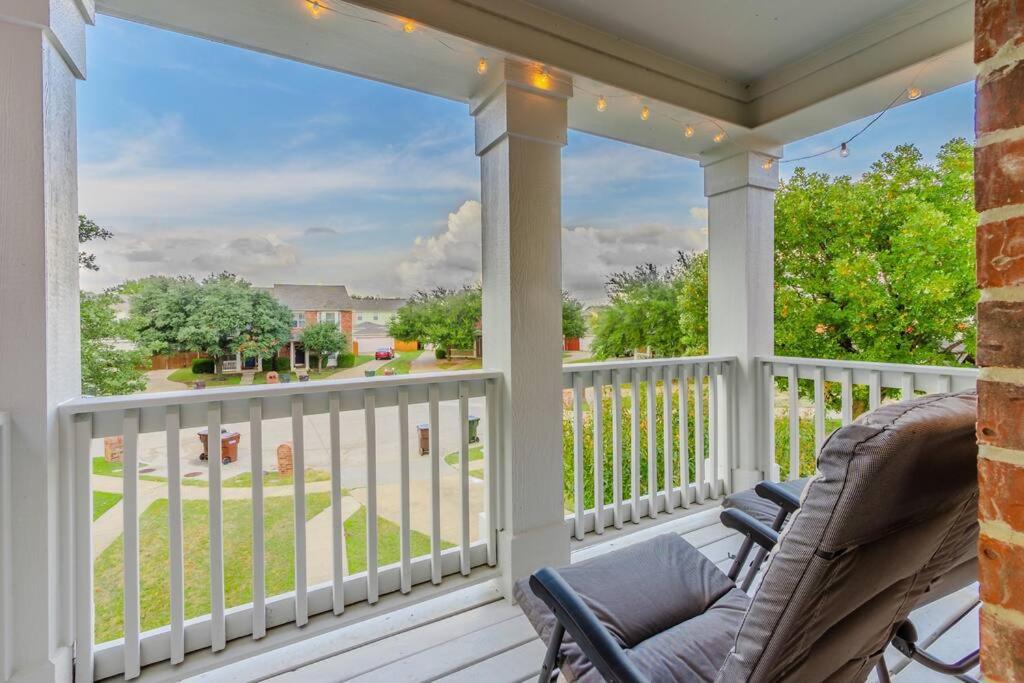 a porch with a chair and a view of the street at Cozy 2BD/3BA with Balcony/Patio/Free Parking/Fast Wifi! 5min to Downtown Plano! in Plano