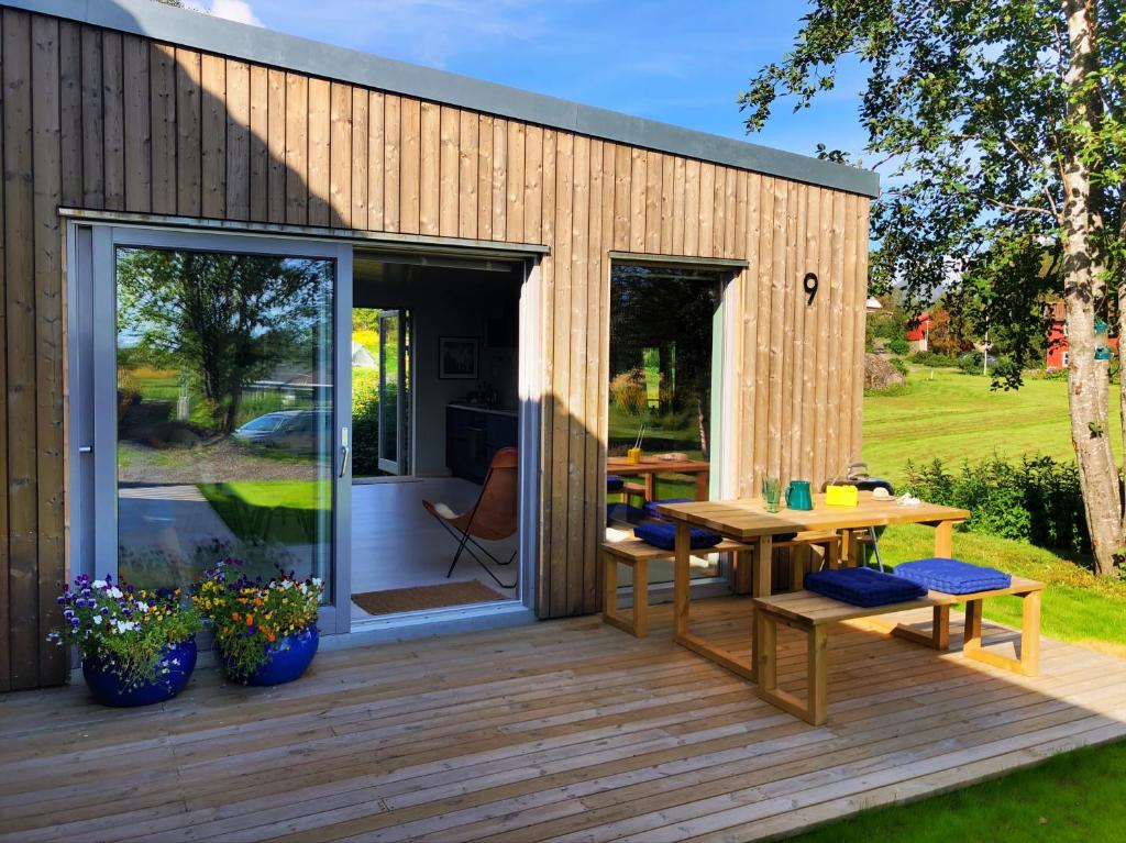 a wooden deck with a table and benches on a house at Lofoten Holiday in Kabelvåg