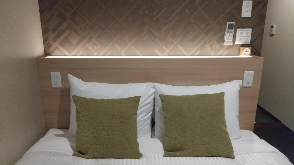 Postel nebo postele na pokoji v ubytování Hotel Reference Tenjin III
