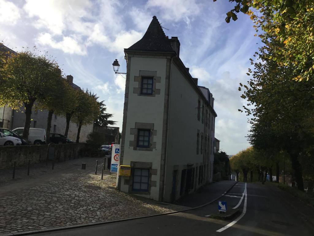 a small white building with a tower on the side of a street at Quartier historique in Quimper