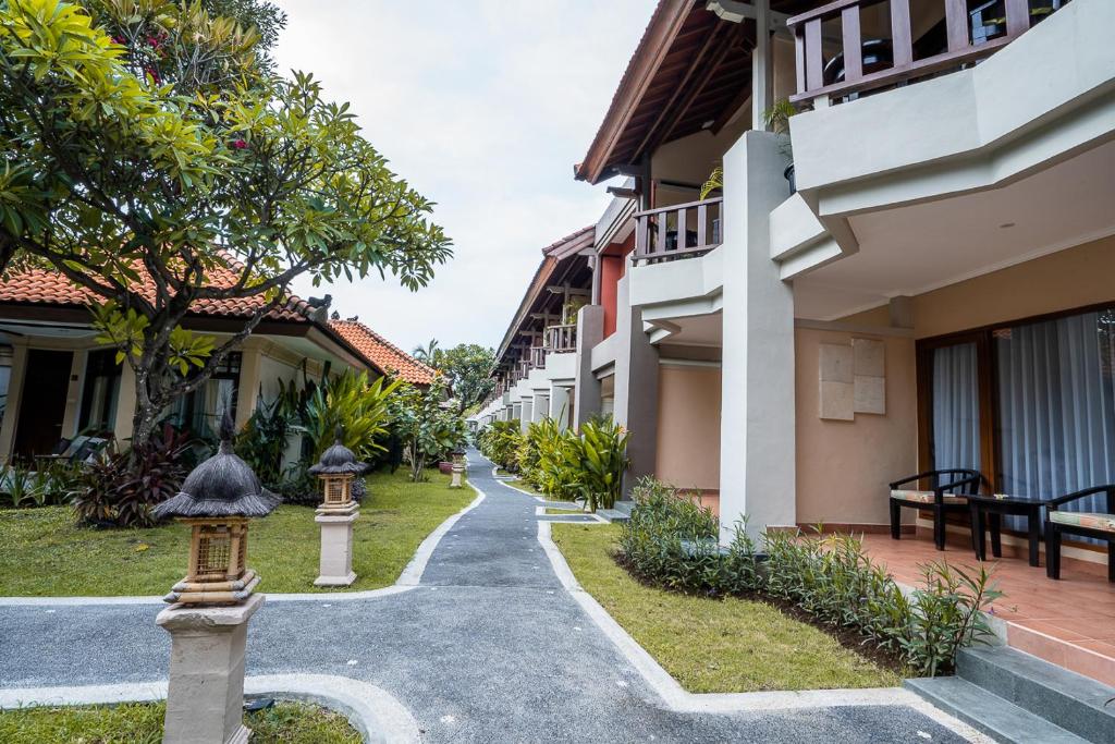 a walkway between two buildings in a resort at New Sunari Lovina Beach Resort in Lovina