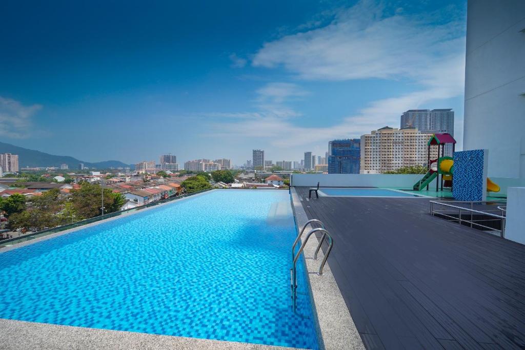 a swimming pool on the roof of a building at Avatel Jelutong in George Town