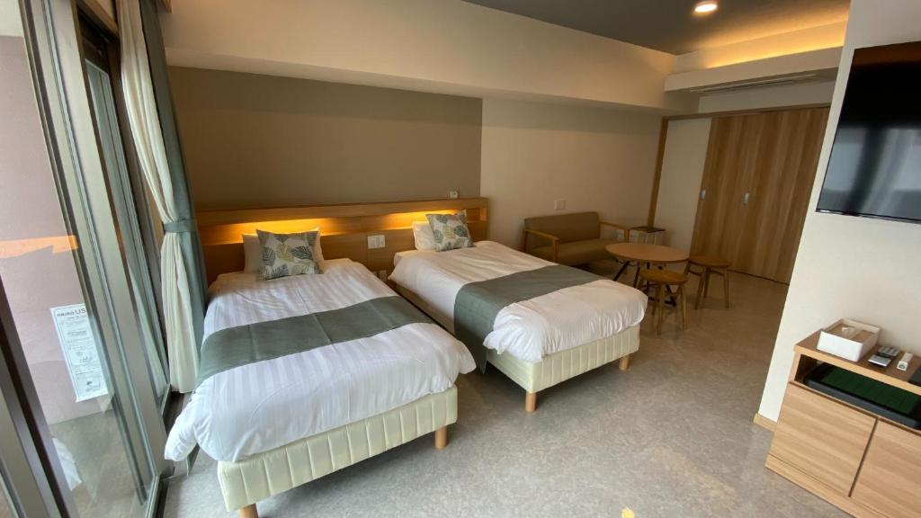 Tabinoteitaku Okinawa Naha 2nd客房内的一张或多张床位