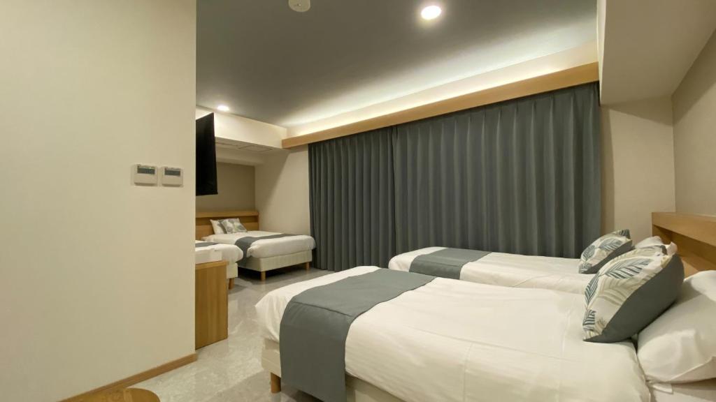Tabinoteitaku Okinawa Naha 2nd客房内的一张或多张床位