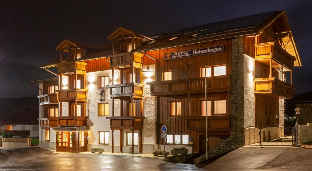 a large apartment building at night with lights at Genusshotel Hohenbogen in Neukirchen beim Heiligen Blut