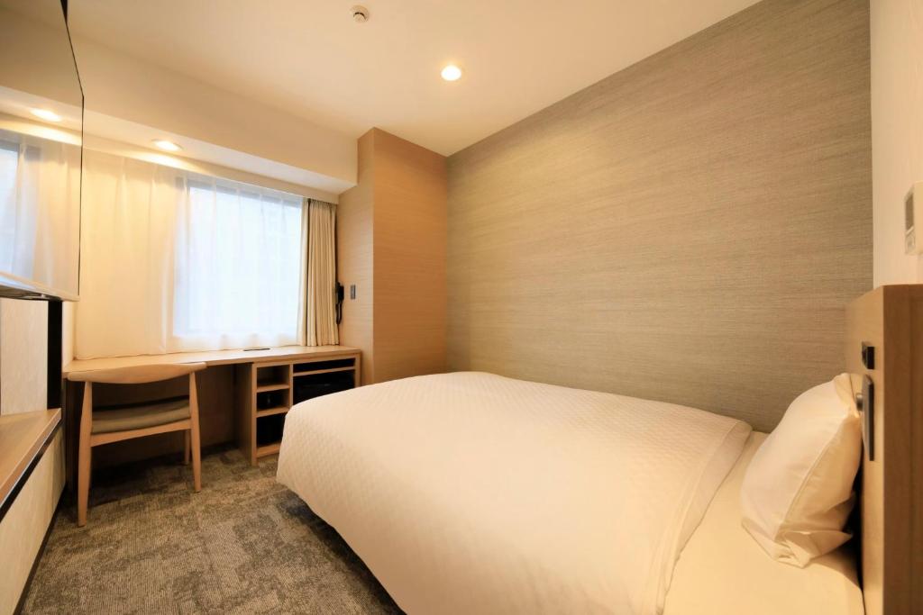 Postel nebo postele na pokoji v ubytování Via Inn Prime Akasaka