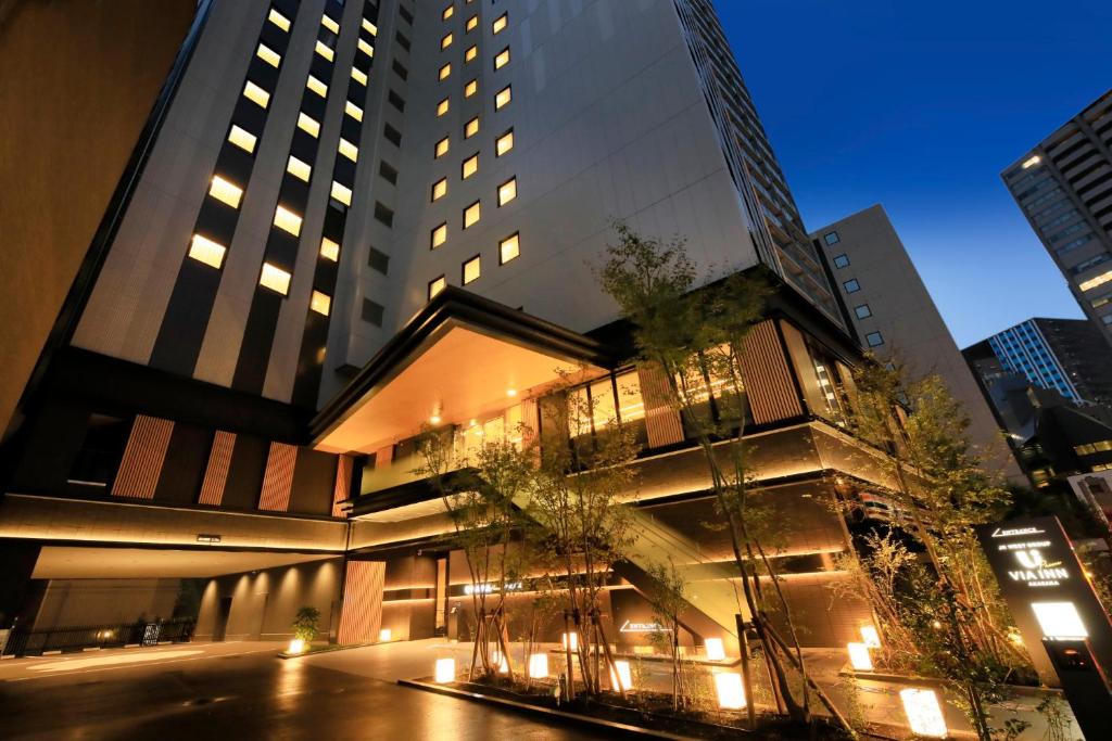 a building in a city at night with lights at Via Inn Prime Akasaka in Tokyo