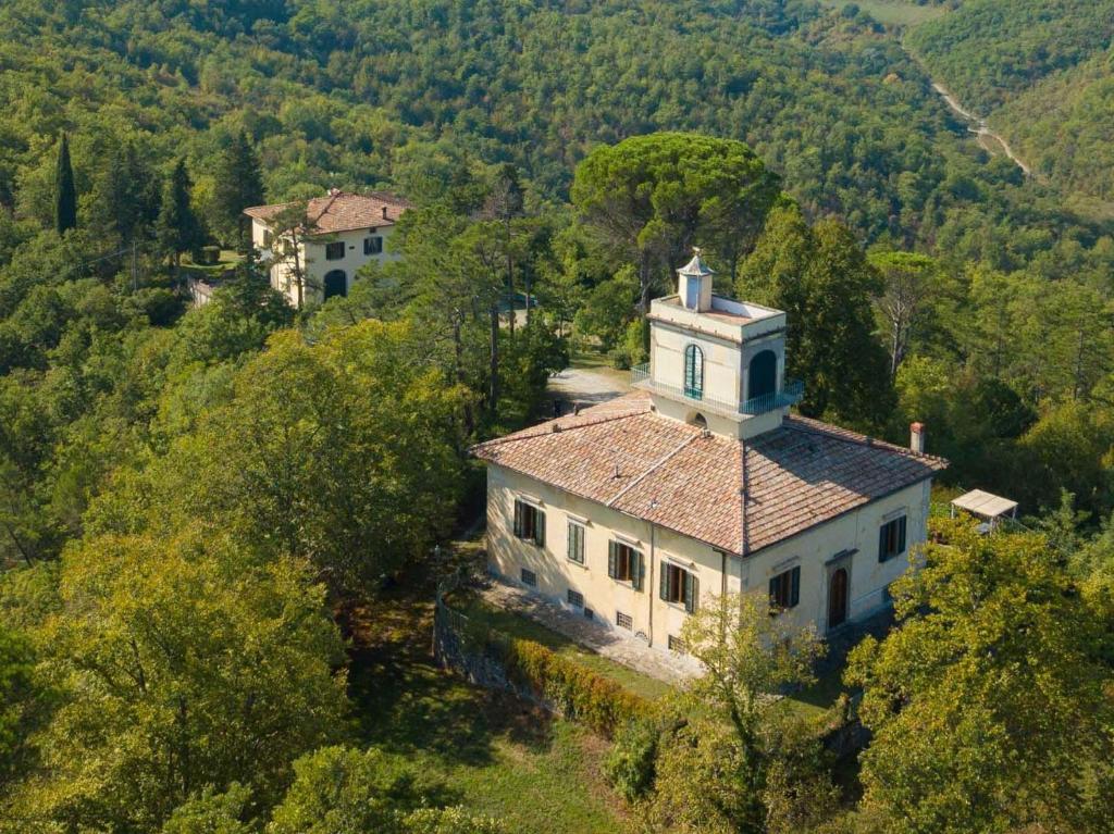 an aerial view of a house with a tower at Villa Votanidi by VacaVilla in Borgo San Lorenzo