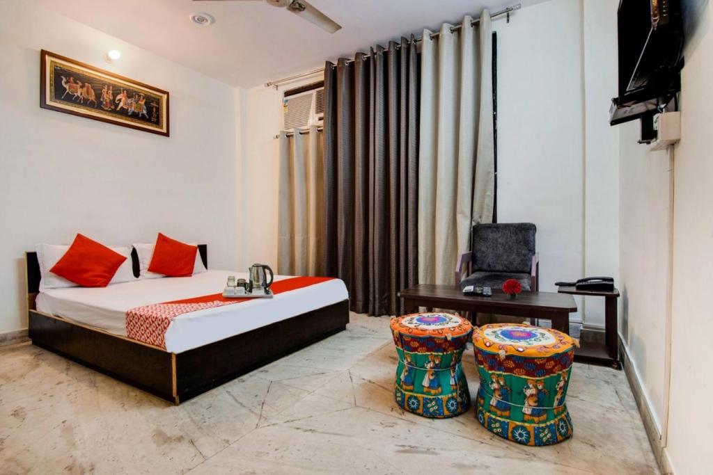 a bedroom with a bed and a desk and a chair at Royal Retreat By Hotel Aditya Inn in Jaipur