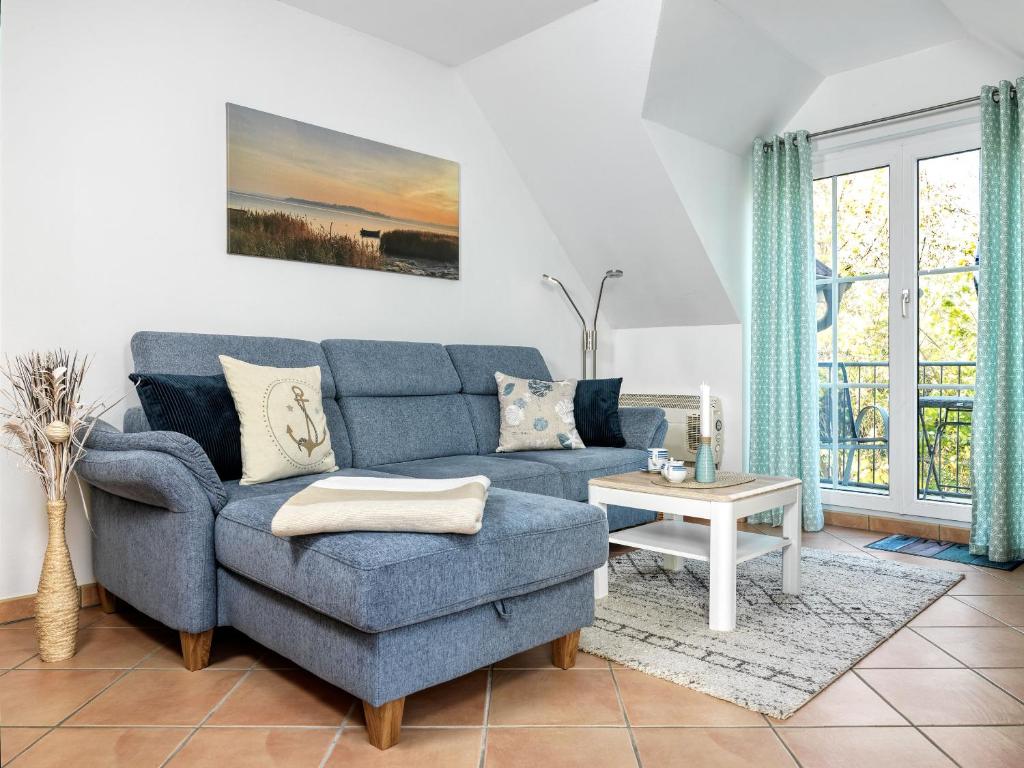 sala de estar con sofá azul y mesa en Gollwitzer Park Seesternchen, en Poel