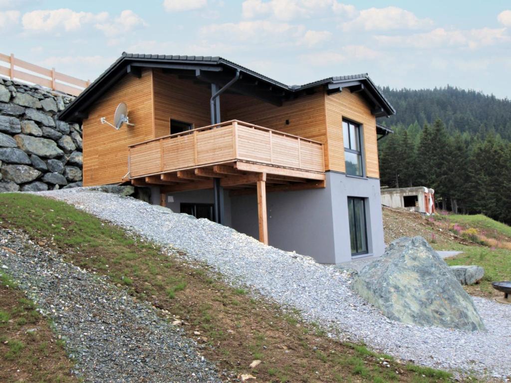 a house on a hill with a balcony at Chalet Mountain Lodge - Klippitztörl by Interhome in Klippitztorl