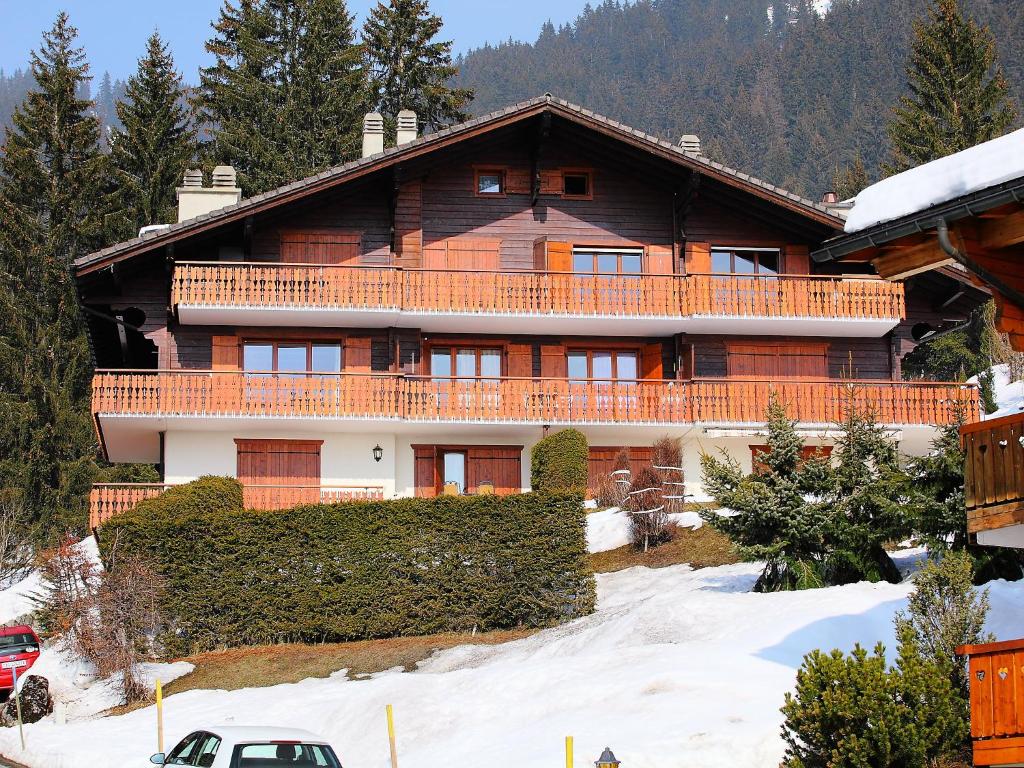 a large wooden house on a snow covered slope at Apartment Le Bouquetin 5 by Interhome in Villars-sur-Ollon