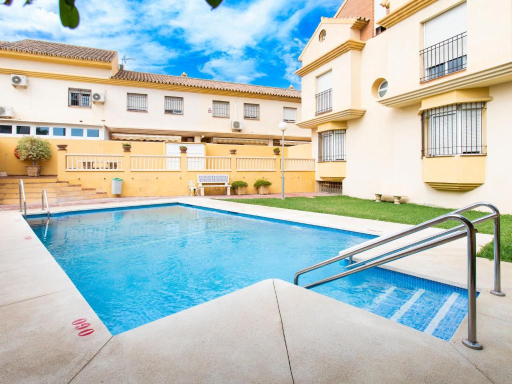 a swimming pool in the courtyard of a apartment building at Holiday Home Villa Corales by Interhome in Torre de Benagalbón