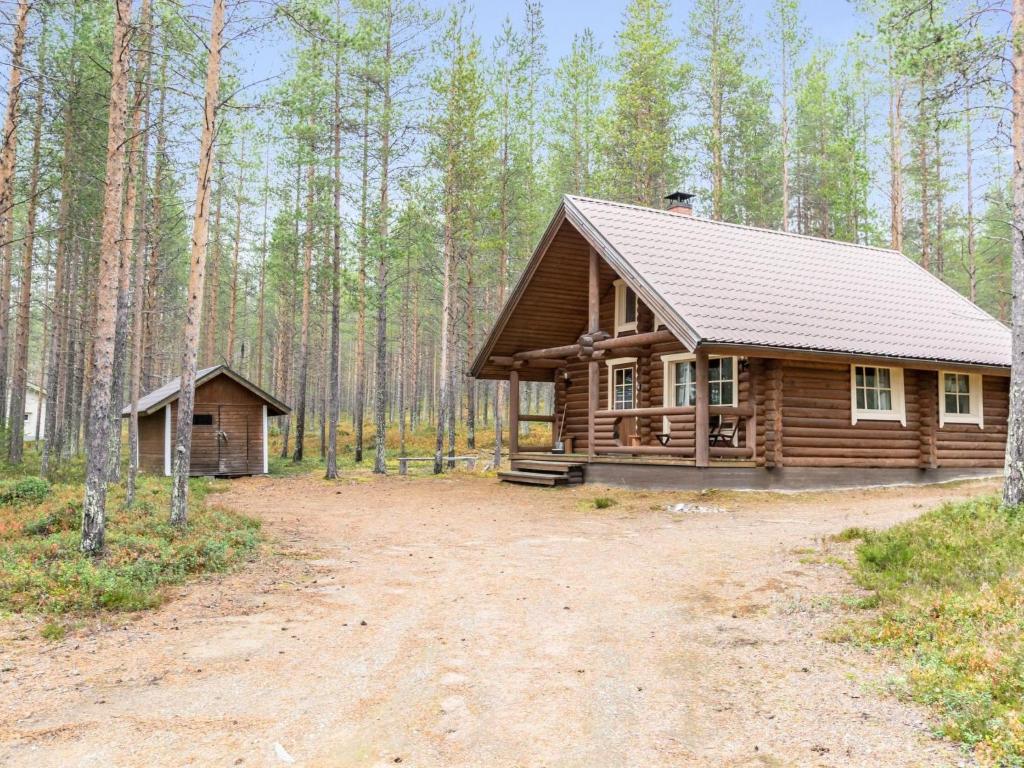 a log cabin in the middle of a forest at Holiday Home Lumomarja by Interhome in Pyhätunturi