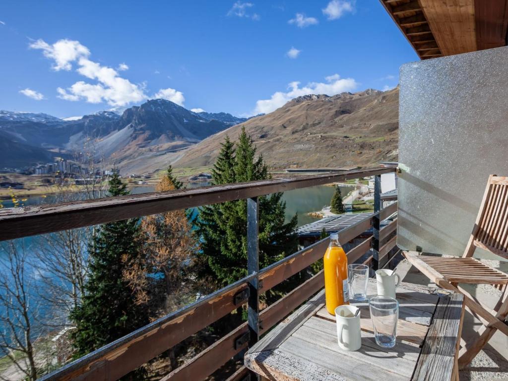 a table on a balcony with a view of a mountain at Apartment Le Grande Motte - Le Lac by Interhome in Tignes