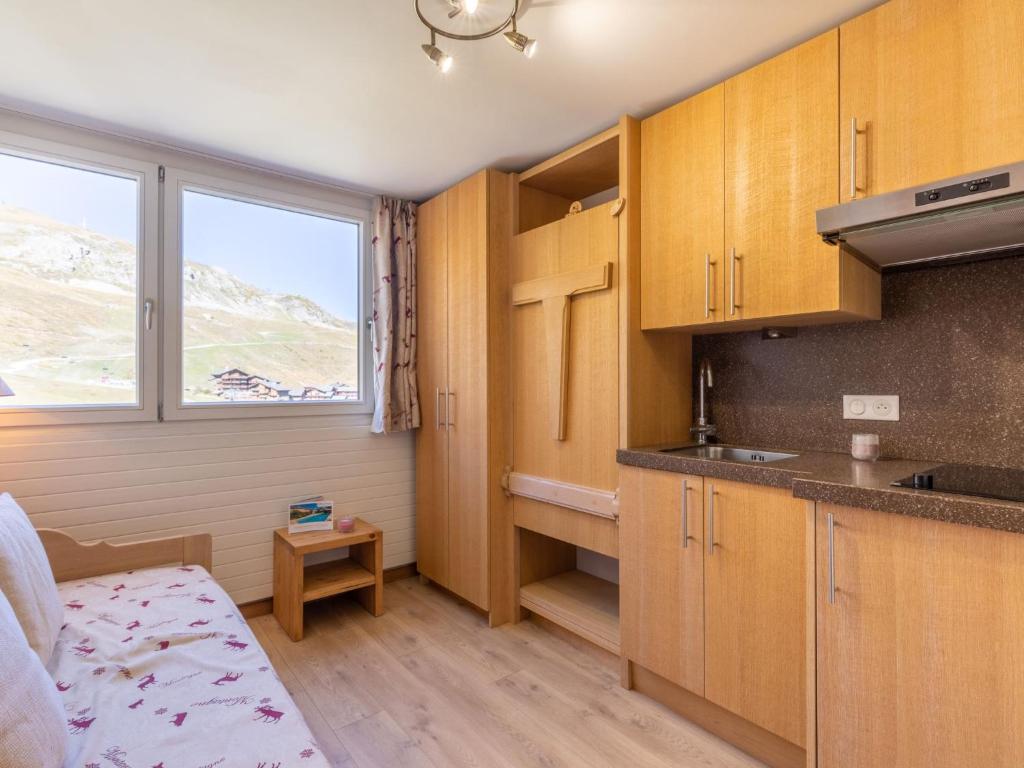 a small kitchen with wooden cabinets and a window at Studio Palafour - Le Lac-5 by Interhome in Tignes